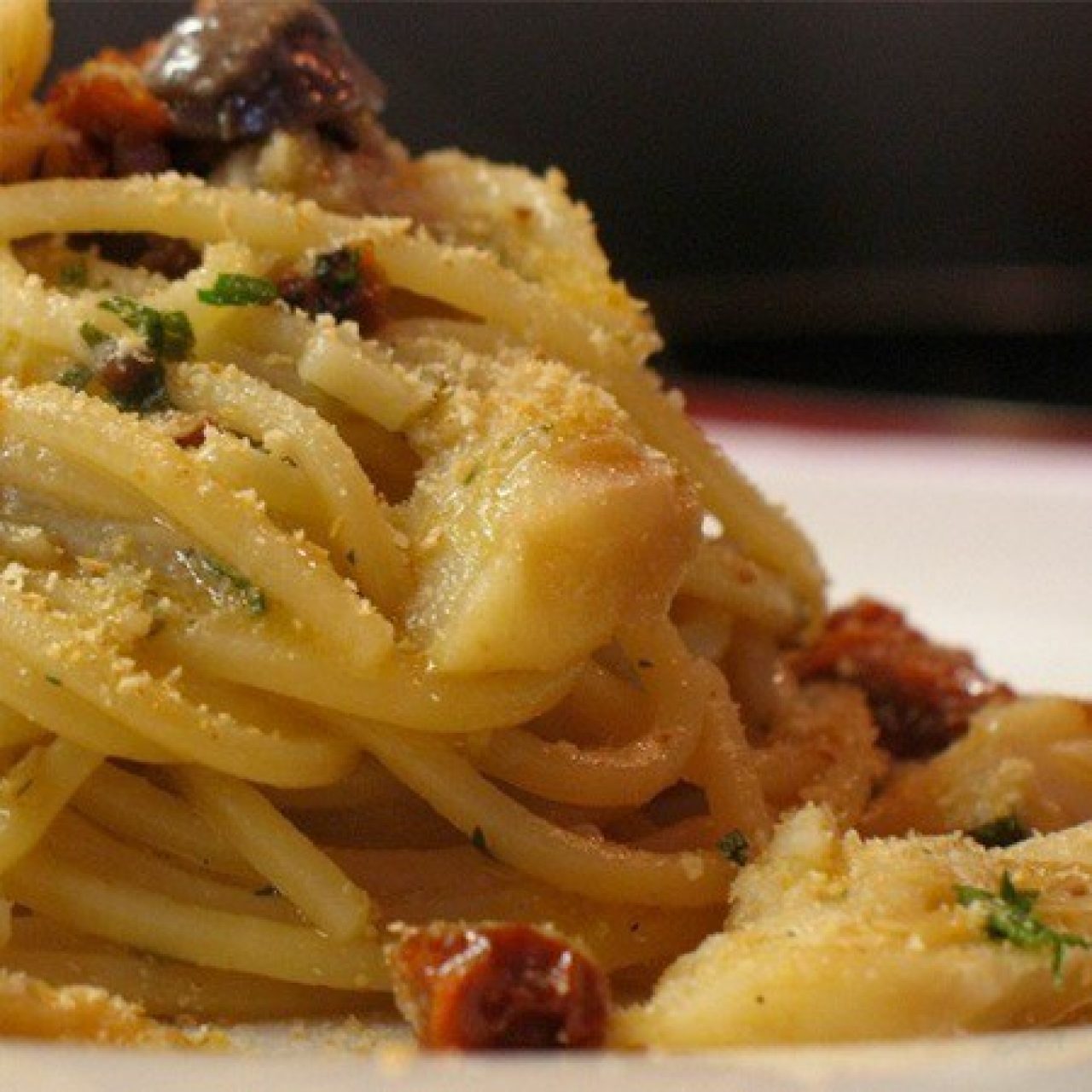 Spaghetti with cod fish, olives, capers and tomatoes